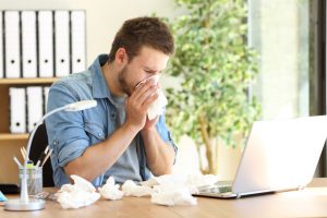 man indoors with fall allergies